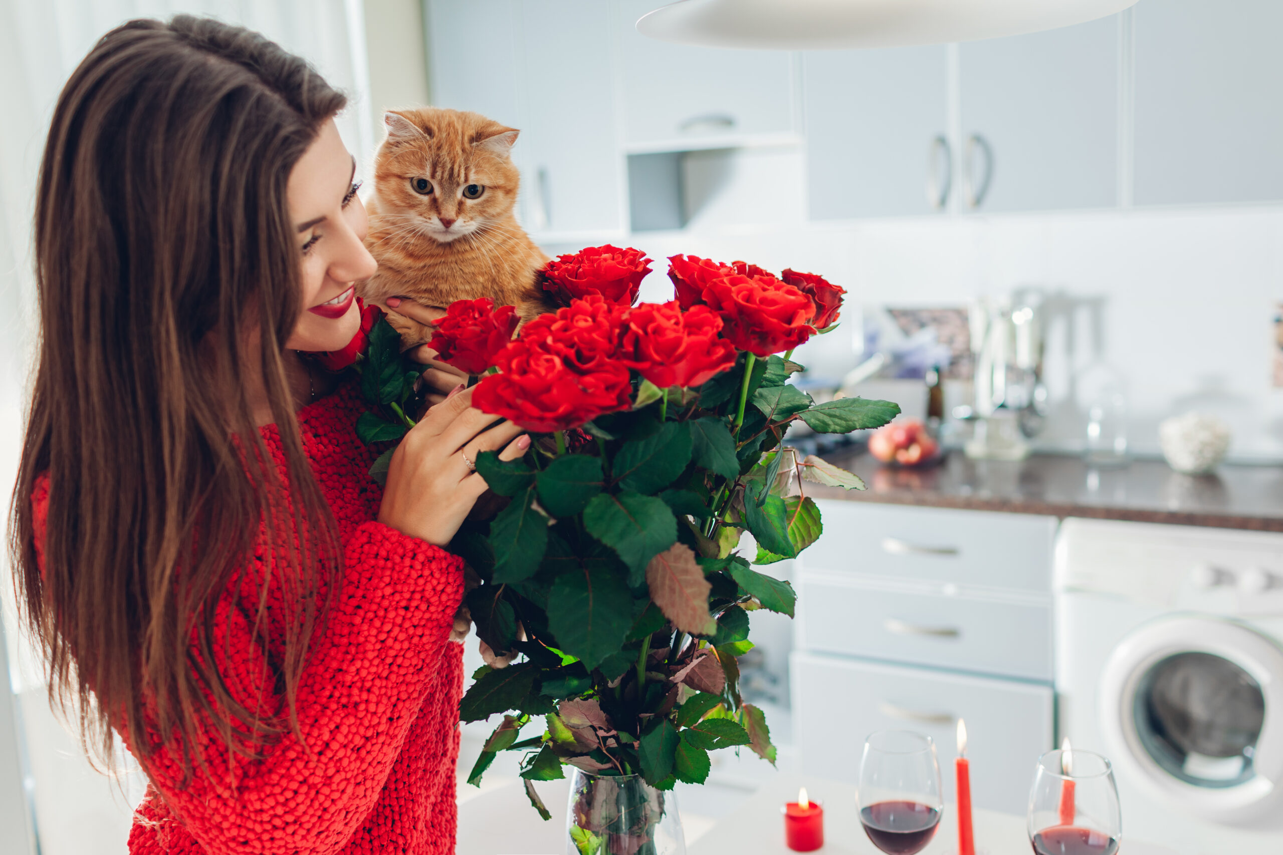 Young,Woman,Found,Red,Roses,With,Candle,,Wine,And,Gift